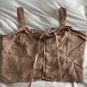 A sexy lace up crop top with zipper on the side.